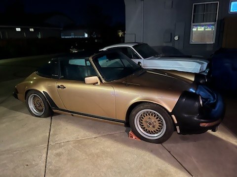 Gold classic British roadster loaded at night
