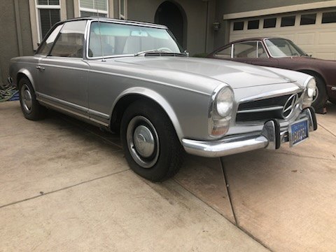 Silver Mercedes-Benz 280SL Pagoda parked in a driveway