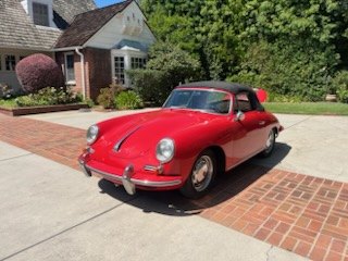 Red Porsche 356 cabriolet on a brick driveway