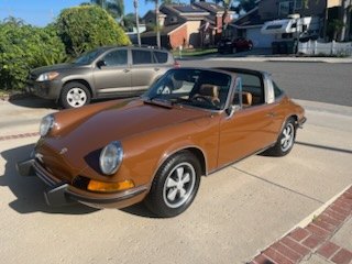 Brown Porsche 911 Targa parked on a suburban street