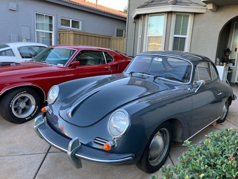 Grey Porsche 356 coupe parked outside a home